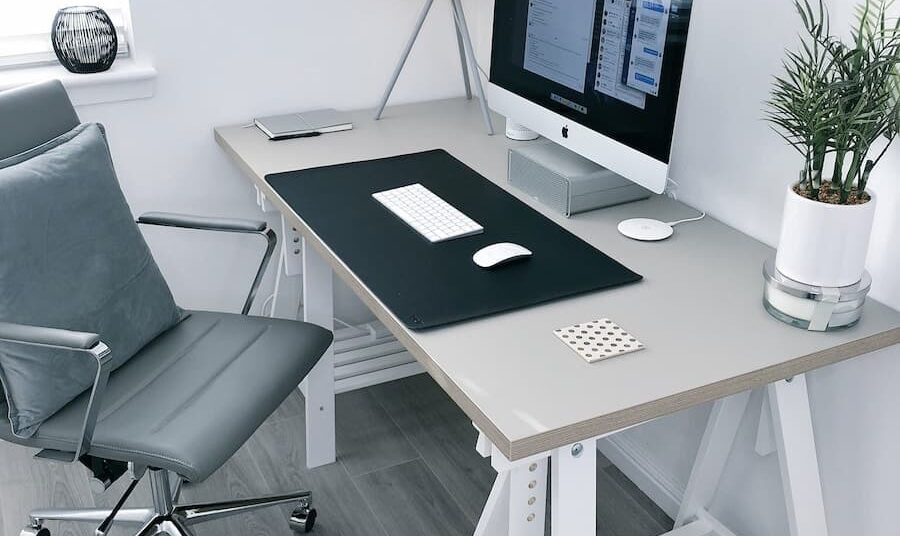 gray leather office rolling armchair beside white wooden computer desk