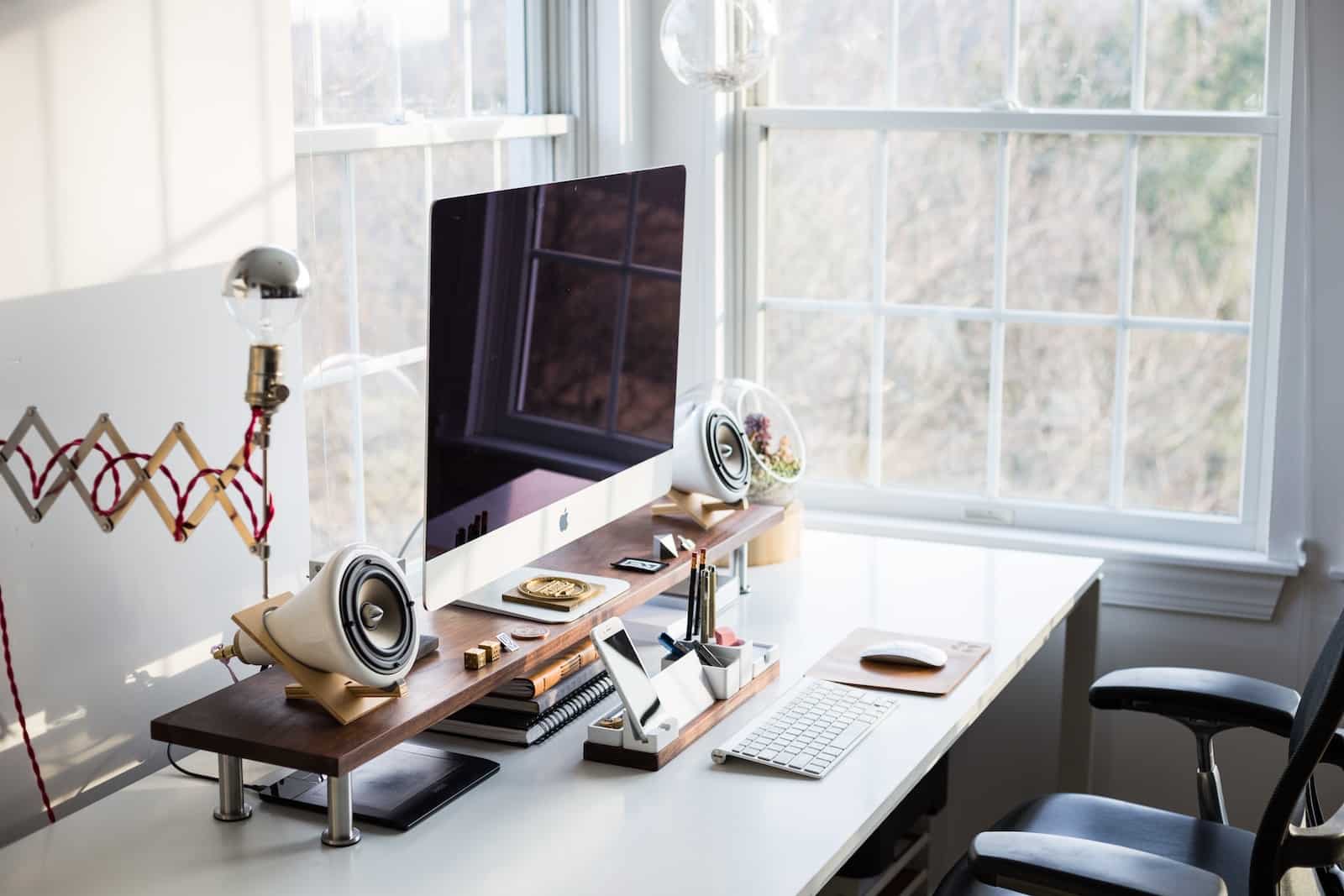 A Well-Organized Home Office: An image of a clean and well-organized home office space is essential. It should depict a clutter-free desk with a comfortable chair, a neatly arranged computer setup, and good lighting. This image emphasizes the importance of having a dedicated and ergonomic workspace.