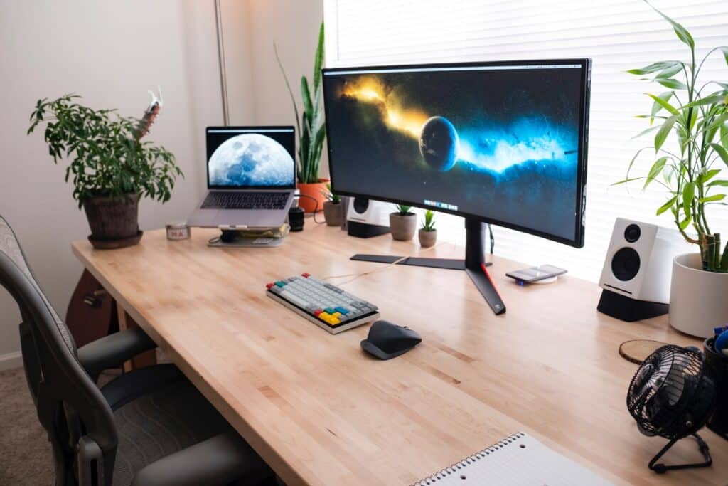 black flat screen computer monitor on brown wooden desk - Photo by Luke Peters on Unsplash