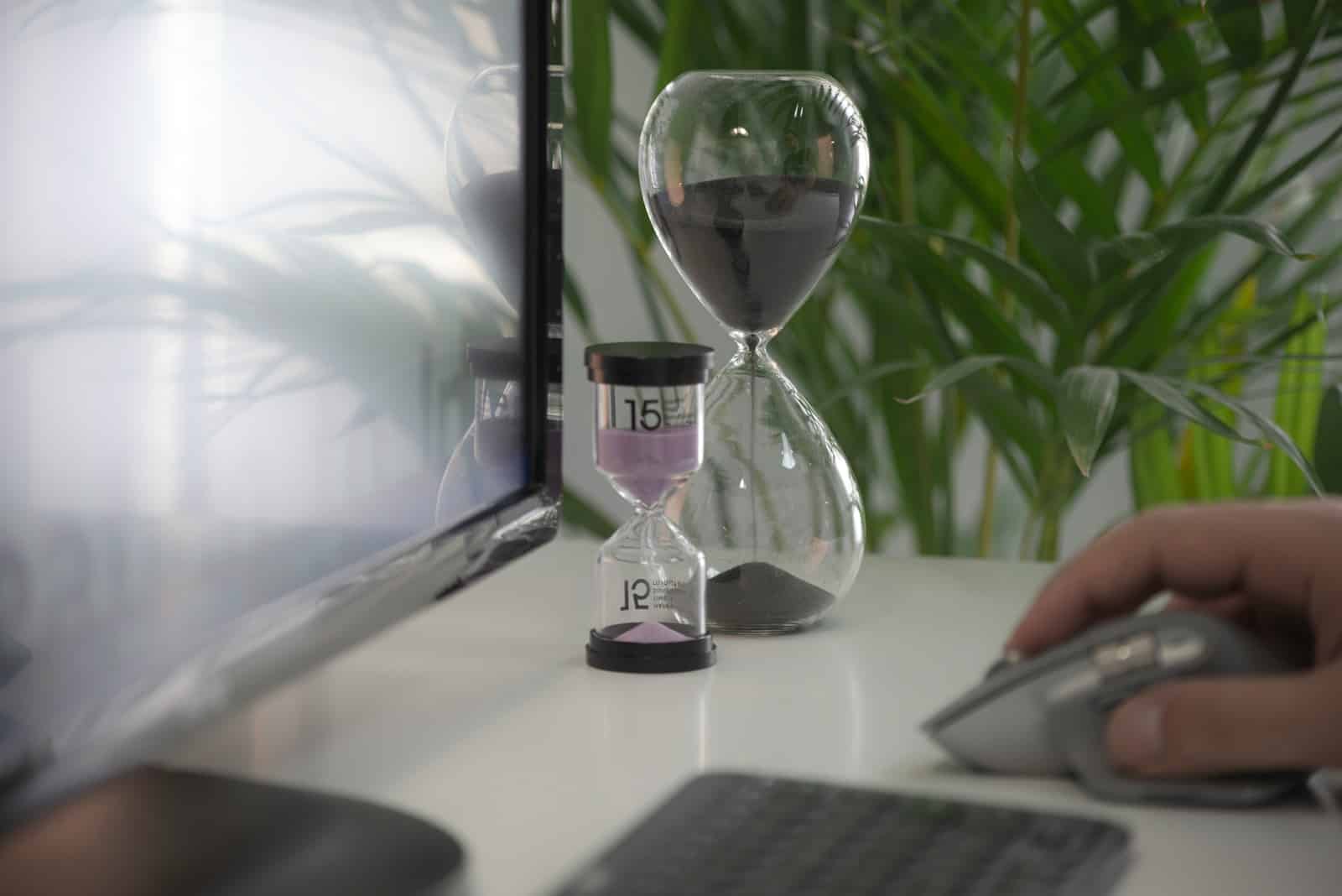 The Importance of Prioritization - clear hour glass on white table